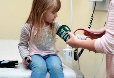 Young girl getting blood pressure checked