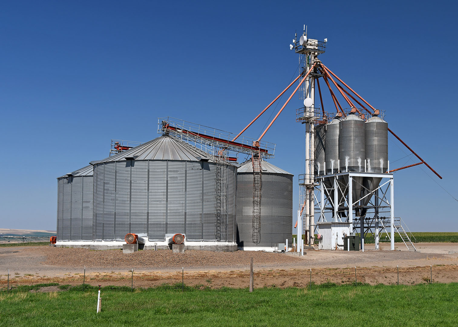 Produce silos and conveyor near onion field outside Hermiston Oregon