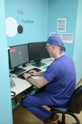 Dr. Michael Yurth, Northwest Dental Residency Program Director, prepares to update electronic charts.