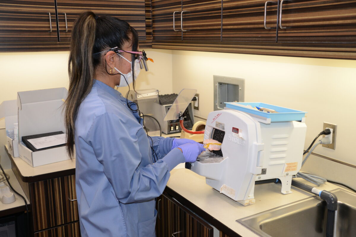 Yanina Diaz, a resident in the Northwest Dental Residency Program, trims a stone denture model at the Toppenish Medical-Dental Clinic.