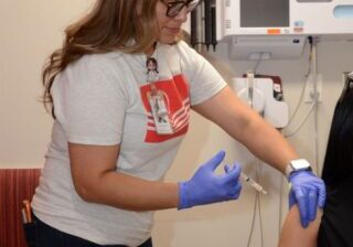 Blanca Soto-Lira prepares give a vaccination injection to a patient. 