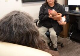 Elida Leonard, a breastfeeding peer counsellor, talks with a WIC client.  