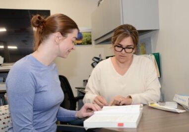 Elly McEachern (left) and Ruby Aguilar, ARNP Residents in the Sollus Advanced Practice Clinician Residency, study when they are not seeing patients. 