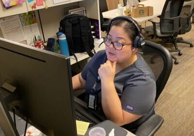 Mattie Bazan, a member of the Chronic Care Management Nurse Team, talks with a patient by phone. 