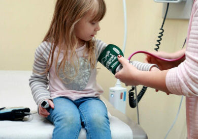 Young girl getting blood pressure checked