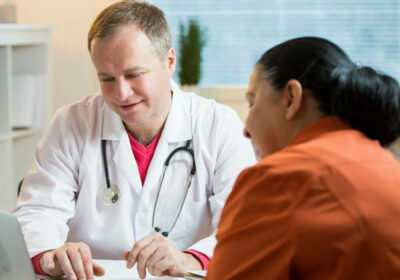 Male doctor reviewing medical paperwork with a female patient