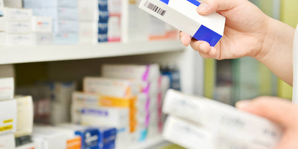 Pharmacist putting medication on a shelf